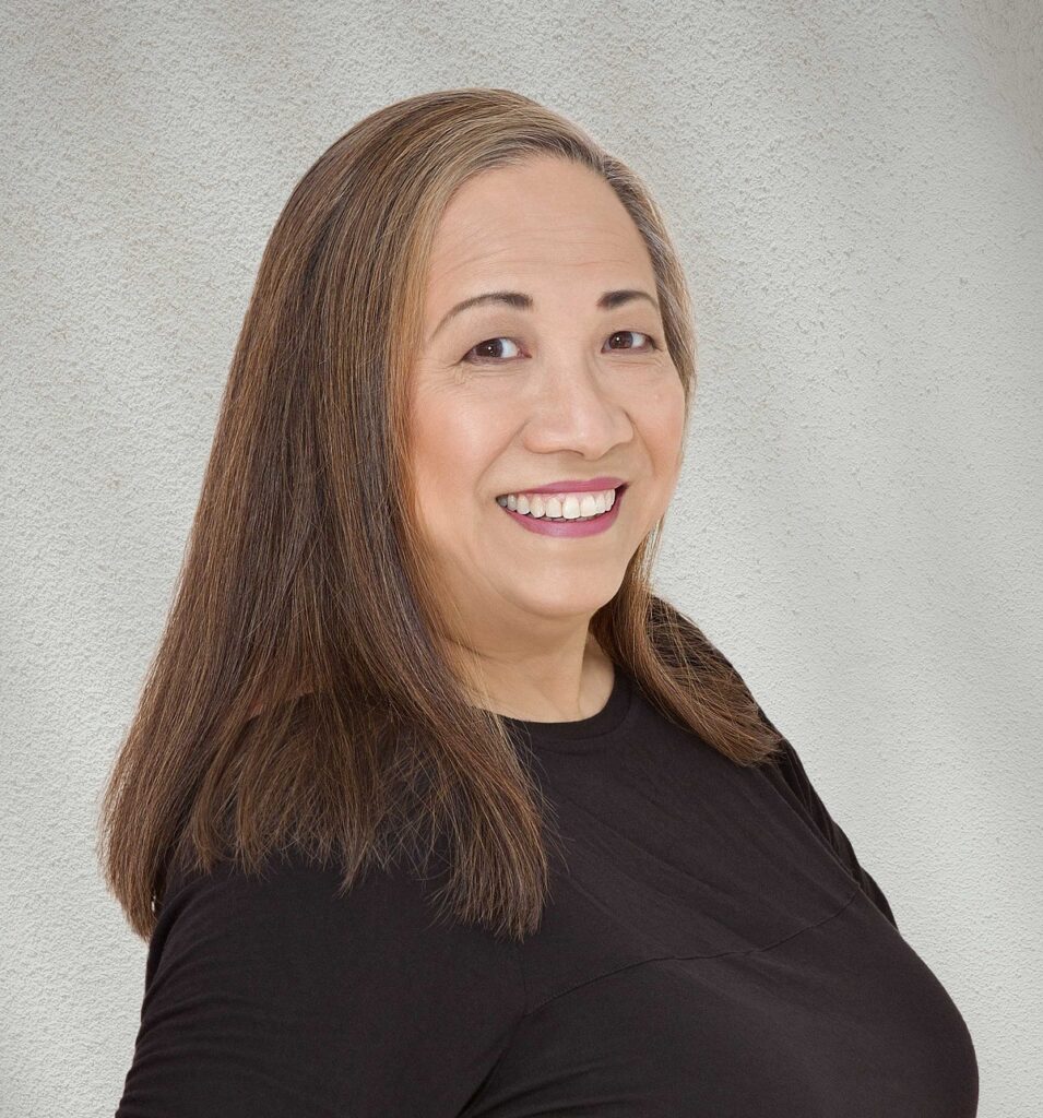 Portrait of a woman with straight brown hair and a black shirt